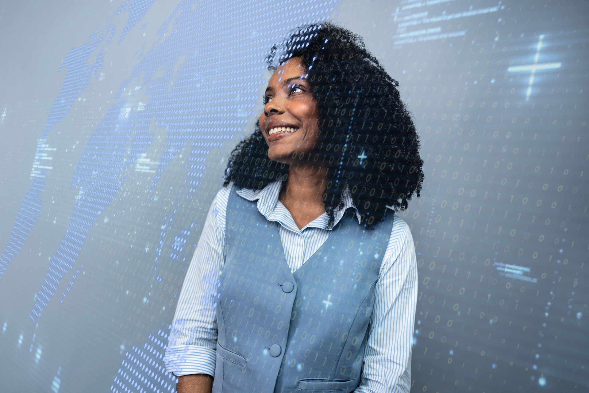 Visionary professional woman smiling with a futuristic overlay of a world map and digital data.